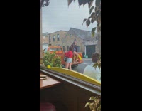 Woman jacket sit behind orange pickup truck