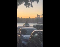 Guy stands on car roof for video