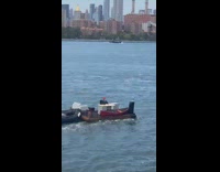 Guy sits white desk wood platform river 