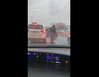 Man gets out of white car dances in traffic