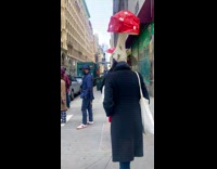 2 women with mushroom hats cross street 