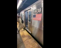 Passenger evacuates to another train on platform