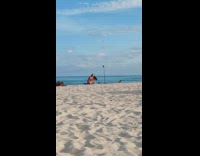 Woman red bikini bend kneel at beach