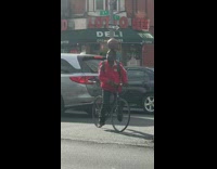 Man in red balances ball on face and head