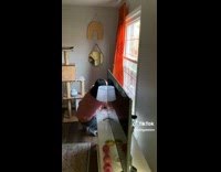 Cat and guy looking out window 