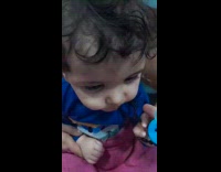 Baby boy flips around pacifier inside mouth