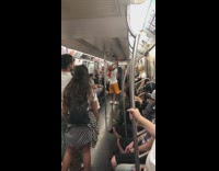 Guy yellow shorts red durag flips hat onto head and dances on subway train