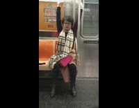 Woman raising arms up and down on subway train 