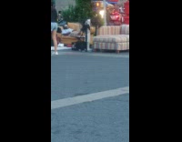 Man lays and chills on yellow couch in public hip hop song