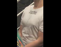 Guy wears a white tshirt that says Full of grace Sit on my face on subway