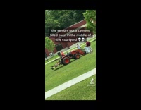 Red tractor forklift trying to remove cement filled oven 