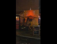 Two dinosaurs sits on restaurant patio 