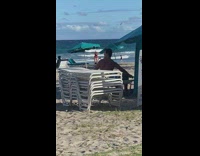 Woman in red top tiktok dance at the beach