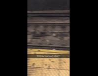 Two rats crawl on subway train tracks and meet each other