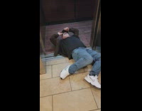 Guy pushes himself on floor into elevator 