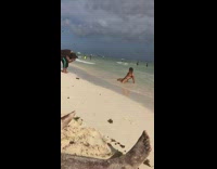 Man green briefs kneel flex muscle beach