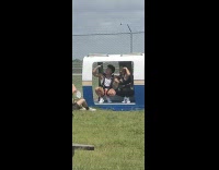 Couple flex biceps inside small train car