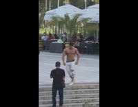 Shirtless body builder guy white pants stairs
