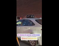 White car has speakers tied to the top of the car