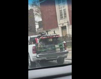 Pickup truck with ATV and fake deer in the bac k