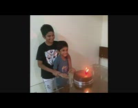 Little boy blows out birthday candles cake