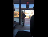 Men walking out squished by automatic folding door 