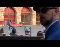 Collab IITW - Woman with airpods black blouse tiktok dance in the middle of the street