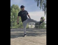 Black shirt guy kicks bounces soccer ball 