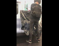 Lady tapes black trash bag over seat