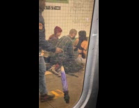 Man massage woman back at subway station