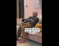 Dad watch tv with cat on lap