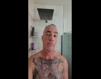 Frog peeks from the window while man showers