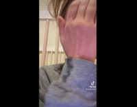 Baby in red staring at mom crying 