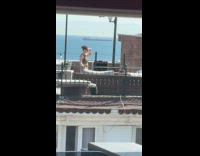 Woman green top tiktok dance on rooftop