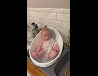 Man Cooks Food as Baby Sits Still