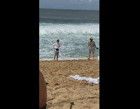 matching couple selfie stick sand