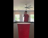 Kid red shirt shoot ball inside cup