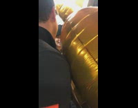 giant gold balloons take up space in subway train