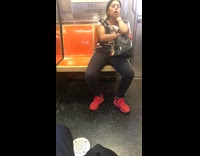 Woman red shoes sleeps with mouth open on subway train holding black backpack