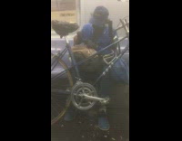 Blue jacket guy black mallet bicycle subway 