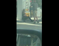 Black shirt girl shell gas station pump 