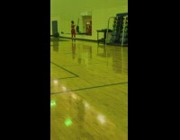 Woman in red outfit dances in front of the mirror