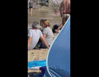 Woman white one piece bikini on top the beach rock