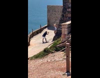 Collab IITW - Woman poses on the slanted brick wall