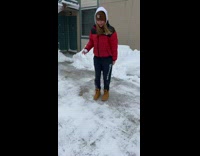 Girl dancing on icy sidewalk slips and falls 