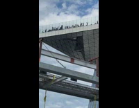 Party seen on edge of building balcony 