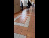 Man wearing skull mask, cloak and stilts 