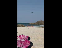 Drone Films Two Blonde Women Laying down at Beach
