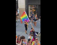 Guy has yellow snake at pride parade