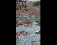 Red truck abandoned in frozen lake